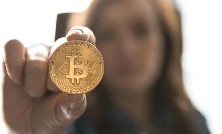 woman holding Bitcoin