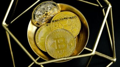 a golden bitcoin sitting on top of a gold plate